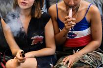 In a Saturday, June 8, 2019, file photo, two women smoke cannabis vape pens at a party in Los A ...
