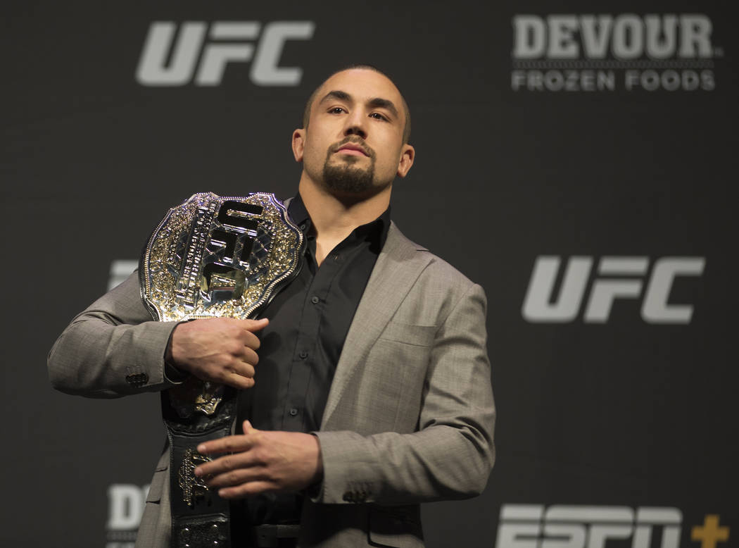 UFC middleweight champion Robert Whittaker holds his belt during a press conference on Friday, ...