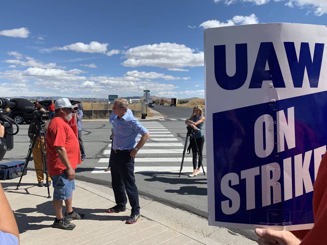 Democratic presidential candidate Tom Steyer speaks to striking auto workers outside a GM parts ...