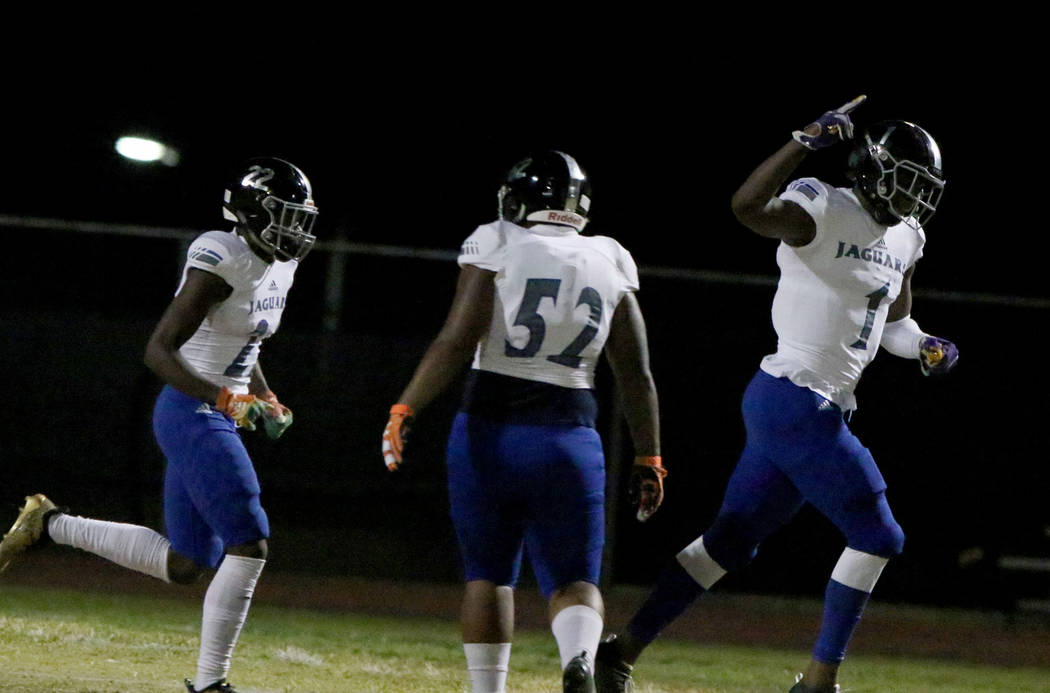 Desert Pines High's wide receiver Darnell Washington (1) celebrates his touchdown with his team ...