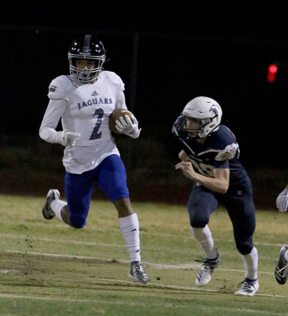 Desert Pines High's wide receiver Deandre Moore (2) returns a punt and goes for a touchdown as ...