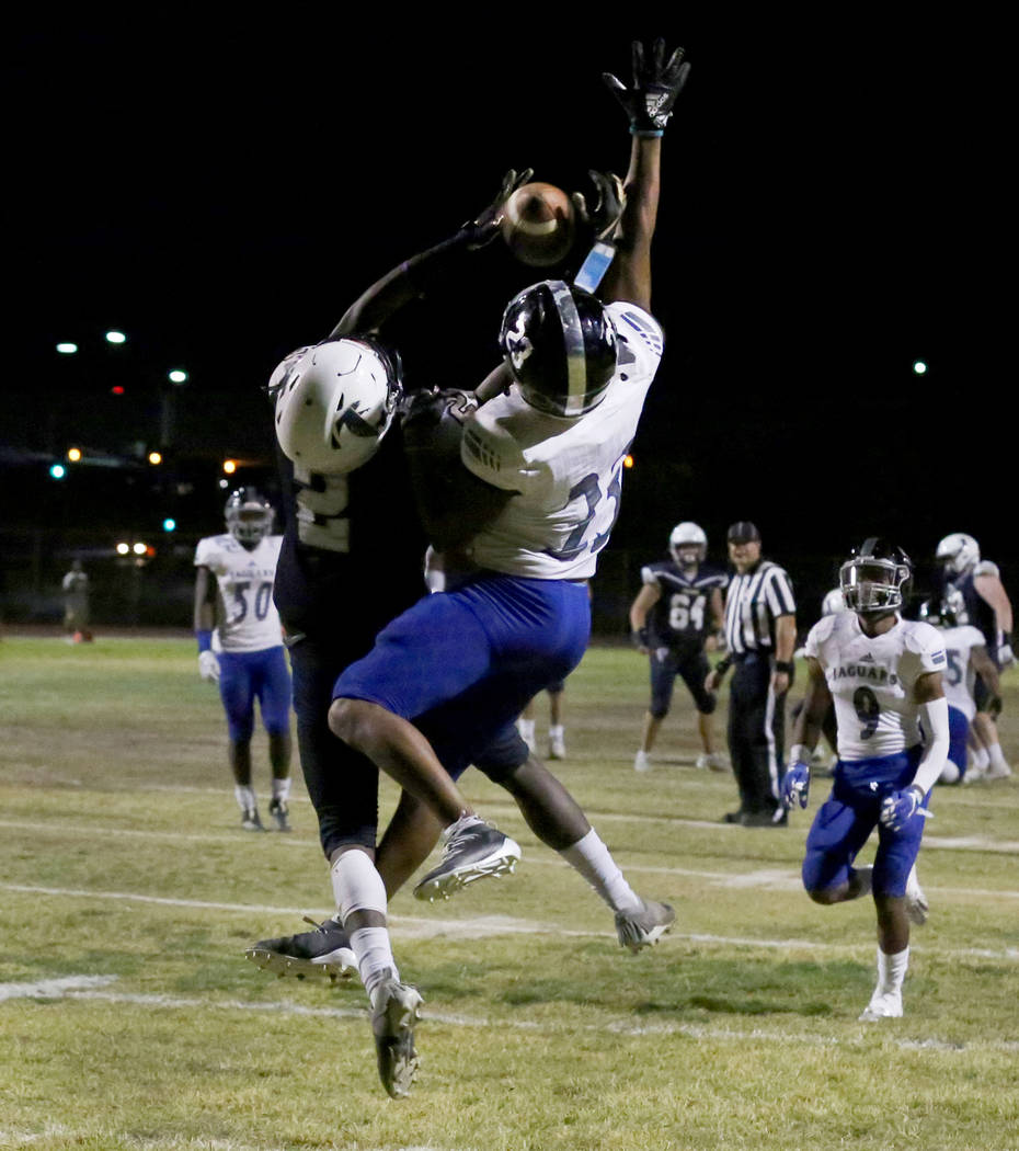 Desert Pines High's cornerback Andrew Williams (23) blocks the ball from Foothill High's wide r ...