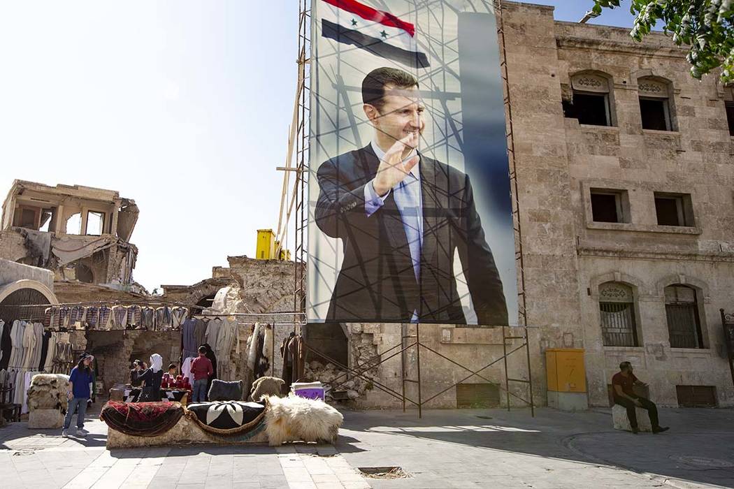 In this photo taken on Friday, Sept. 27, 2019, A huge portrait of Syrian President Bashar Assad ...