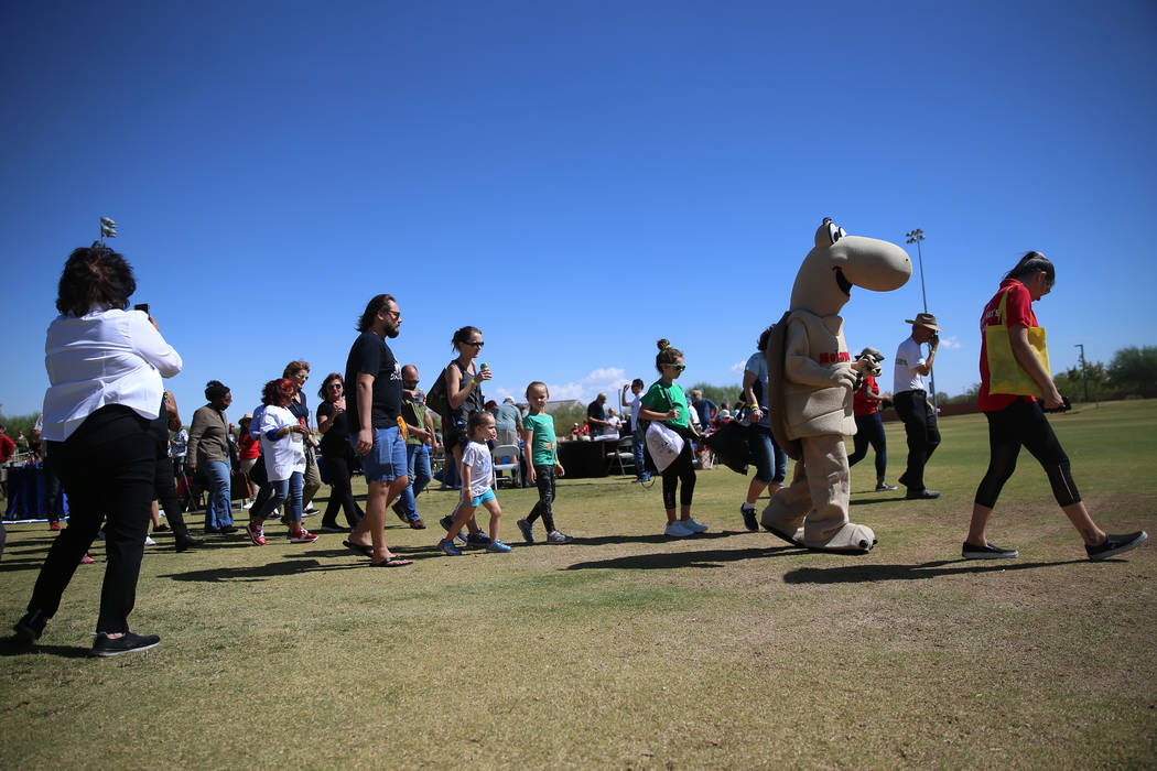 People participate in a nature walk during a celebration of the 3rd annual Public Lands Day at ...
