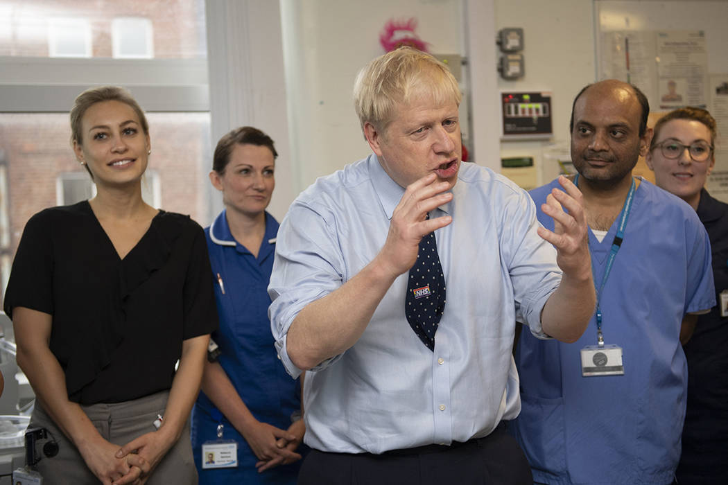 Britain's Prime Minister Boris Johnson speaks during a visit to North Manchester General Hospit ...