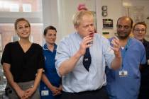 Britain's Prime Minister Boris Johnson speaks during a visit to North Manchester General Hospit ...
