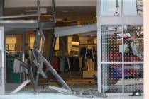 The damaged storefront of the Sears store at Woodfield Mall is seen after a man drove an SUV in ...
