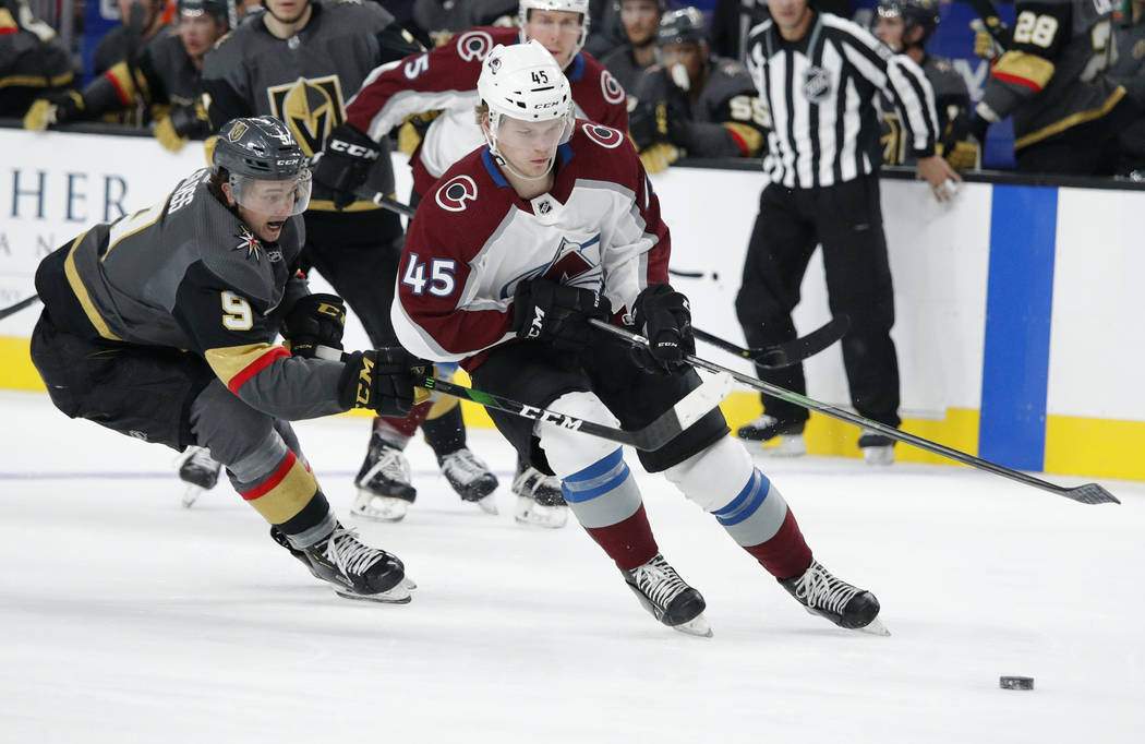 Vegas Golden Knights center Cody Glass (9) vies for the puck with Colorado Avalanche defenseman ...