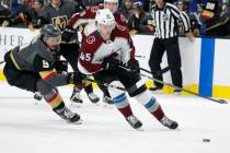 Vegas Golden Knights center Cody Glass (9) vies for the puck with Colorado Avalanche defenseman ...