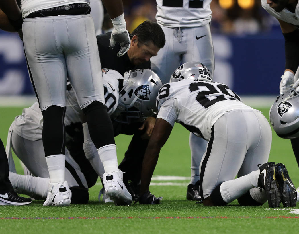 Oakland Raiders cornerback Daryl Worley (20) remains on the field after a play and is checked o ...