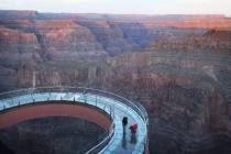 Workers from Highland Glass Products Inc. inspect The Skywalk at Grand Canyon West before under ...