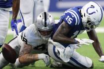 Indianapolis Colts wide receiver Parris Campbell (15) fumbles the football after being tackled ...
