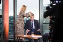 British Prime Minister Boris Johnson has his hair combed as he prepares to appear on a TV polit ...