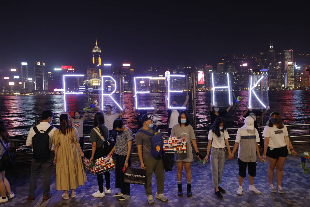 People form a human chain in support of protest movement in the harbor area in Hong Kong, Mond ...