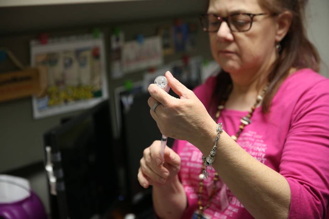 Licensed practical nurse Annmarie Homer gets ready to administer a flu vaccine at the Southern ...