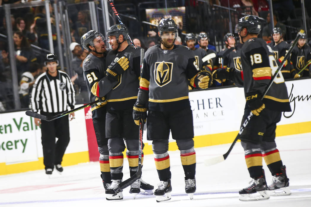 Golden Knights' Max Pacioretty, third from left, celebrates his goal with Nate Schmidt (88) alo ...