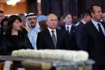 Russian President Vladimir Putin, center, stands before a service for late French President Jac ...