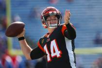 Cincinnati Bengals quarterback Andy Dalton (14) triple playas he warms up before a NFL football ...