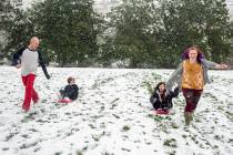 Tommy Little, from left, Cody Little, Kyndra Neal and Tanya Little use the snow accumulation to ...