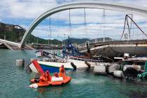 Rescuers work near the site of a collapsed bridge in Nanfangao, eastern Taiwan. Tuesday, Oct. 1 ...