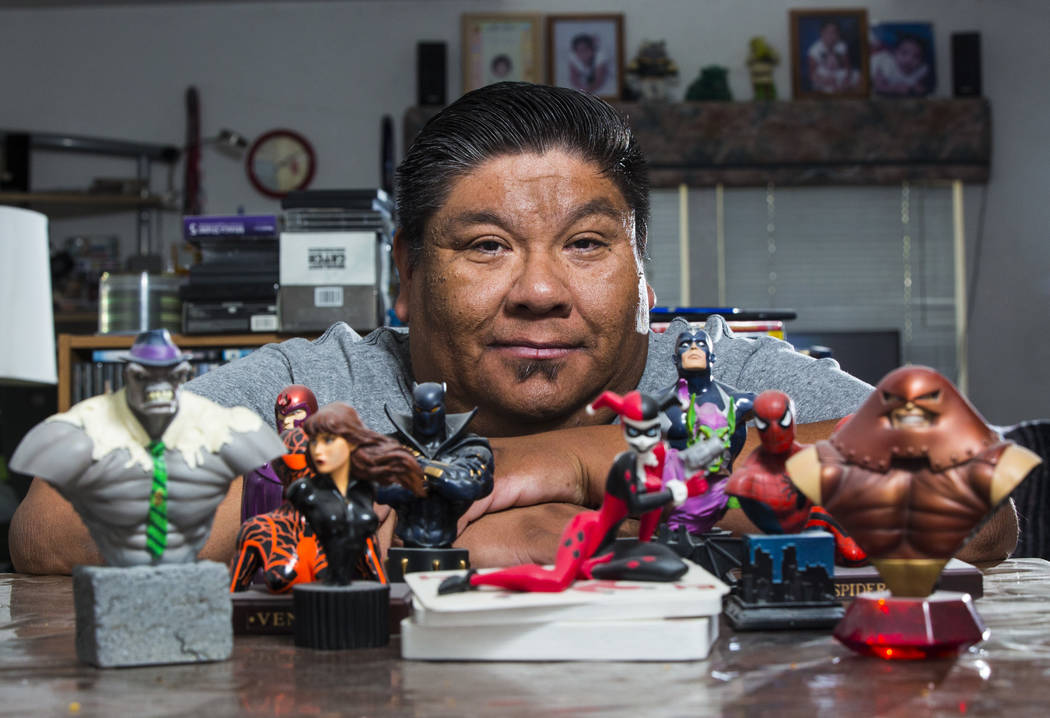 Theo Tso, creator of Captain Paiute, poses with superhero figurines at his home in Las Vegas on ...