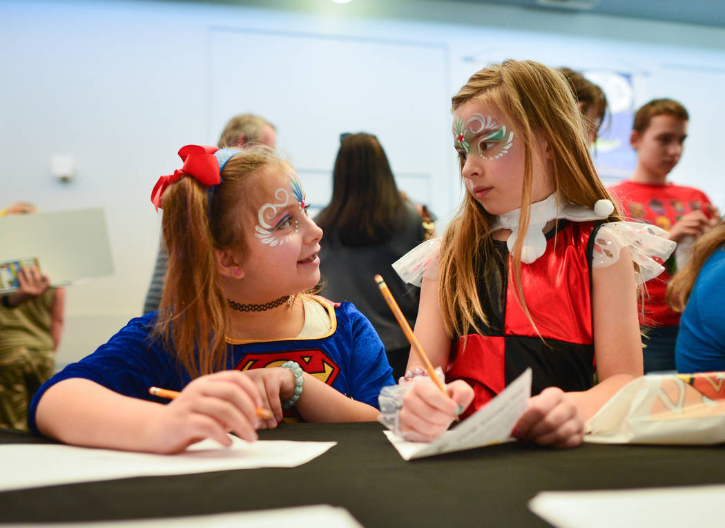 Izabella, left, and Dalayla, right, both eight, make drawings during at the 11th annual Vegas V ...