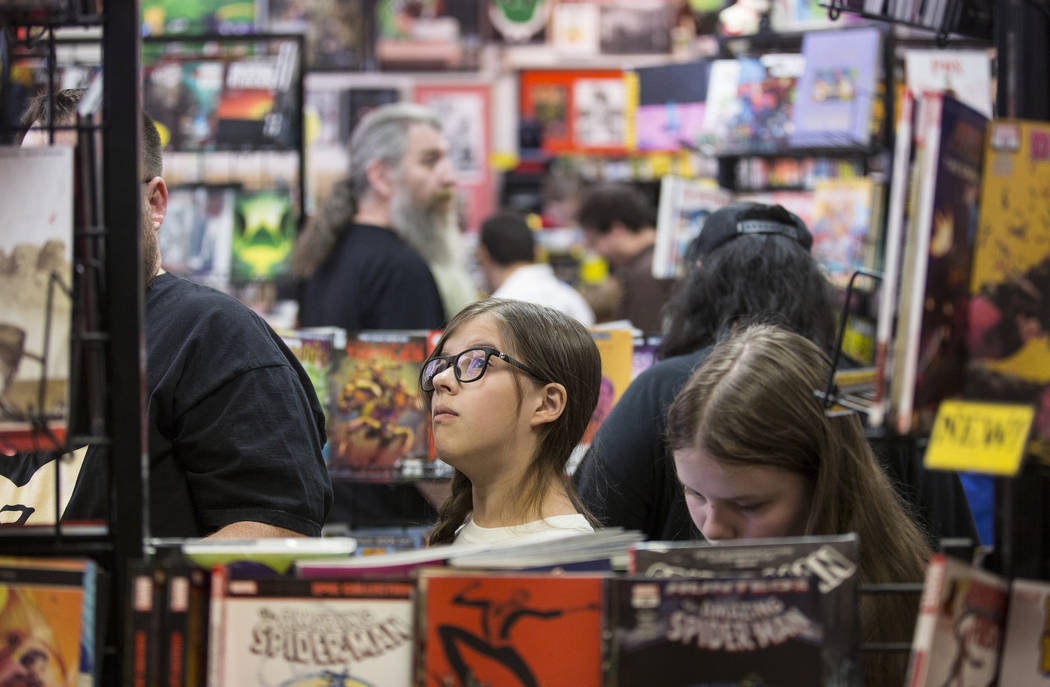 Shoppers peruse the aisles at Alternate Reality Comics during free comic book day at on Saturda ...