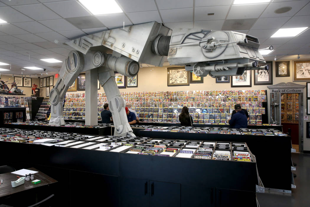 People browse for comics before a visit by DJ Steve Aoki for a signing for his new comic book s ...