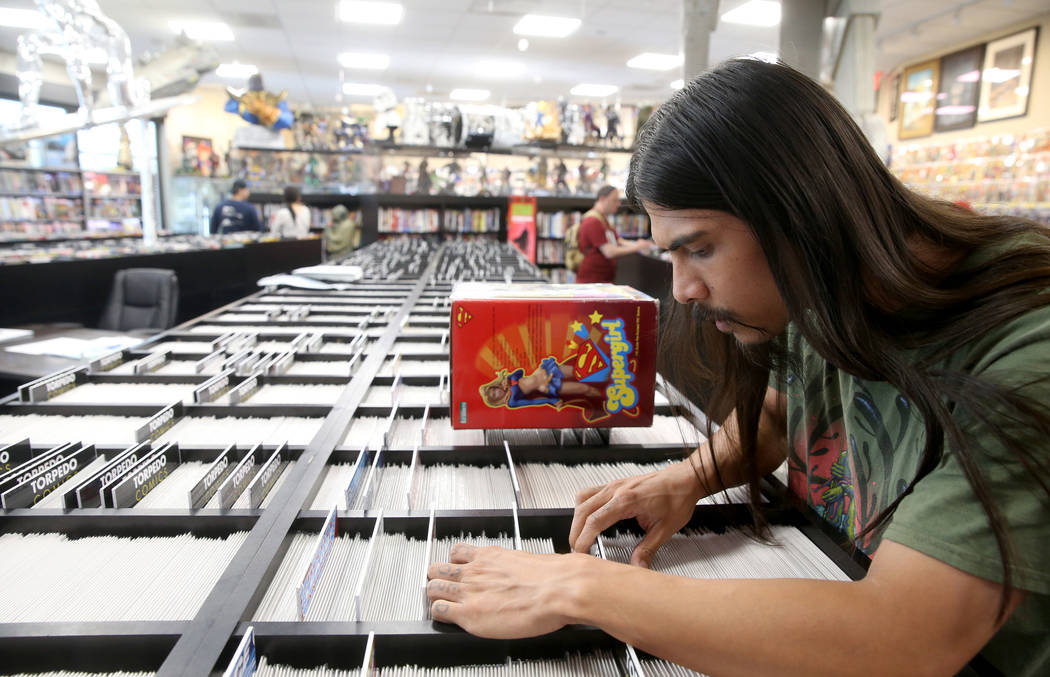 Arick Hortizuela of Henderson browses for comics before a visit by DJ Steve Aoki for a signing ...
