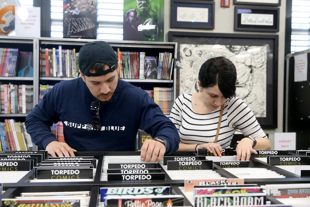 Tony Martinez and Vanessa Rodriguez, both of Fresno, California, browse for comics before a vis ...