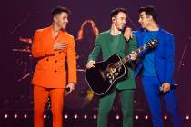 Nick Jonas, from left, Kevin Jonas, and Joe Jonas, of The Jonas Brothers, perform on stage on F ...
