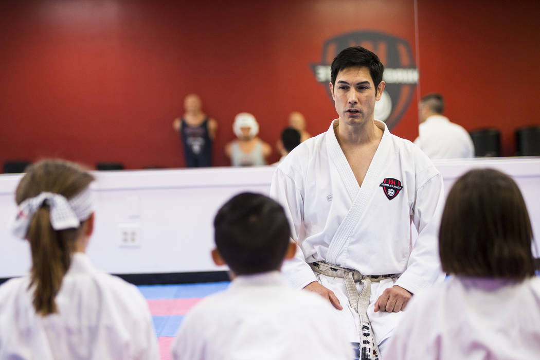 Hiroshi Allen talks with students about positive speech and thinking during a class at Hiro Kar ...