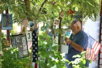 Michael Hyatt, 67, decorates his brother-in-law's tree, Kurt Von Tillow, who was killed during ...