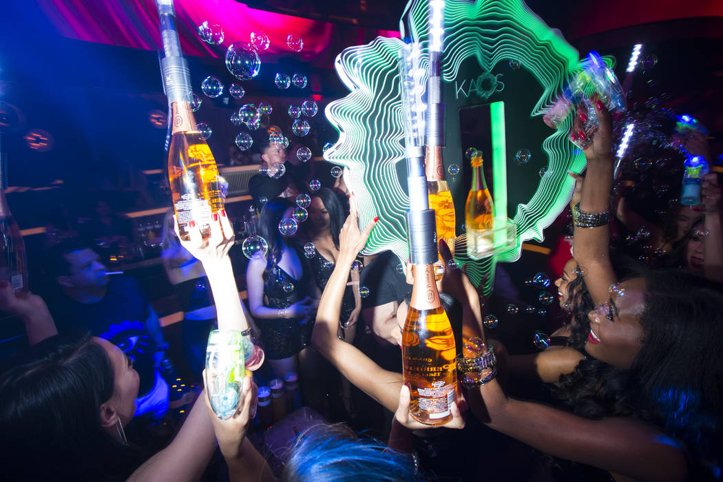 Bottles of champagne are delivered to a table in the nightclub area during the grand opening we ...