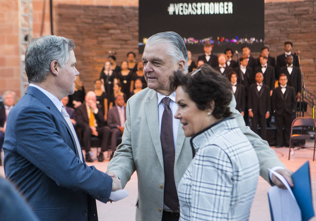 Gov. Steve Sisolak, center, greets MGM Resorts International CEO Jim Murren, left, and U.S. Sen ...