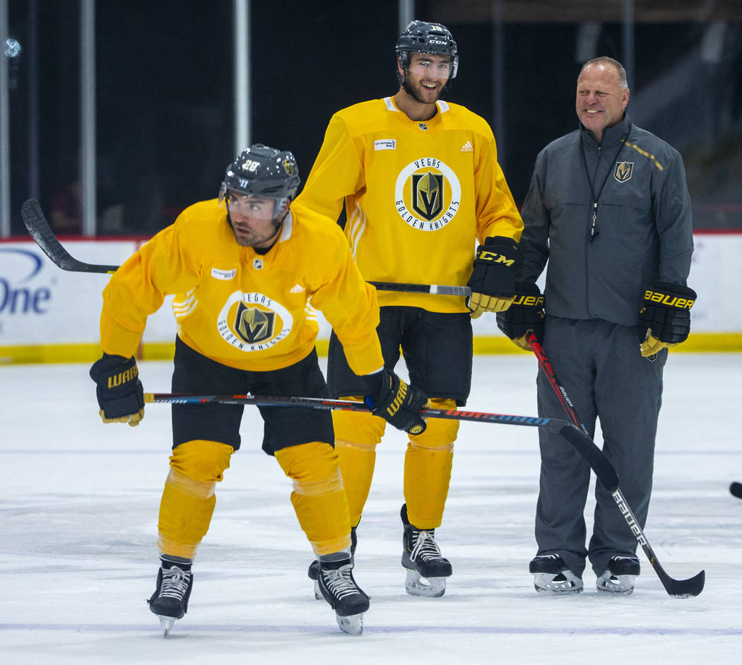 Vegas Golden Knights left wing William Carrier (28, left) and center Nicolas Roy (10) stand wit ...