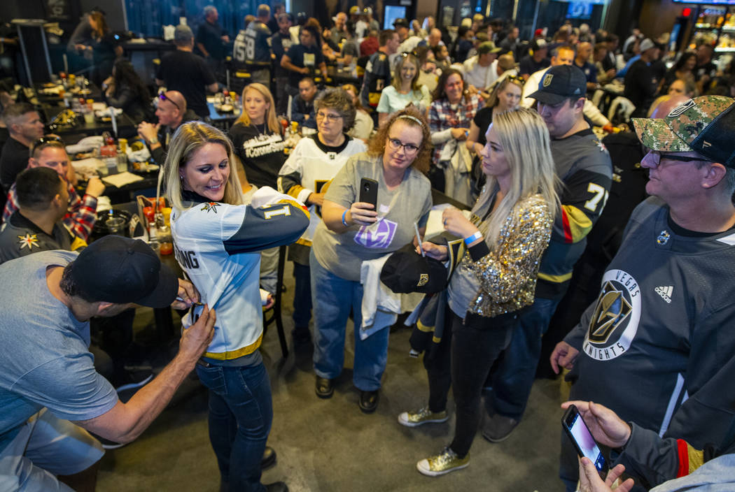 The Vegas Golden Knights Deryk Engelland, left, signs an autograph for Leslie Shaffer with Amer ...