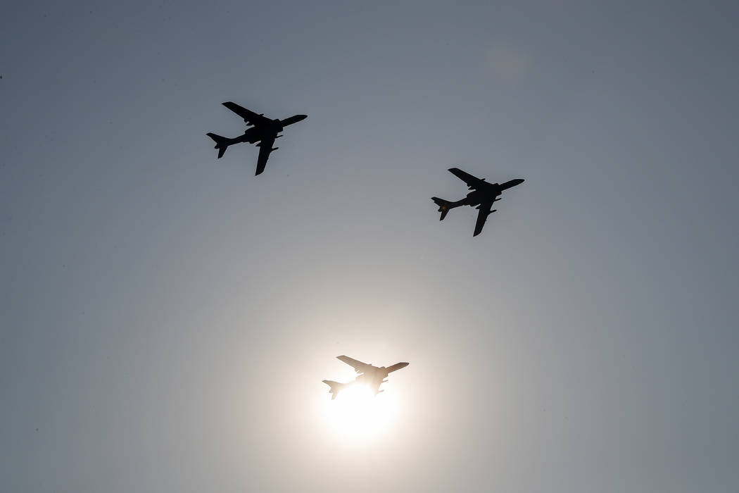 China's H-6 bomber jets fly in formation past the sun during a parade to commemorate the 70th a ...