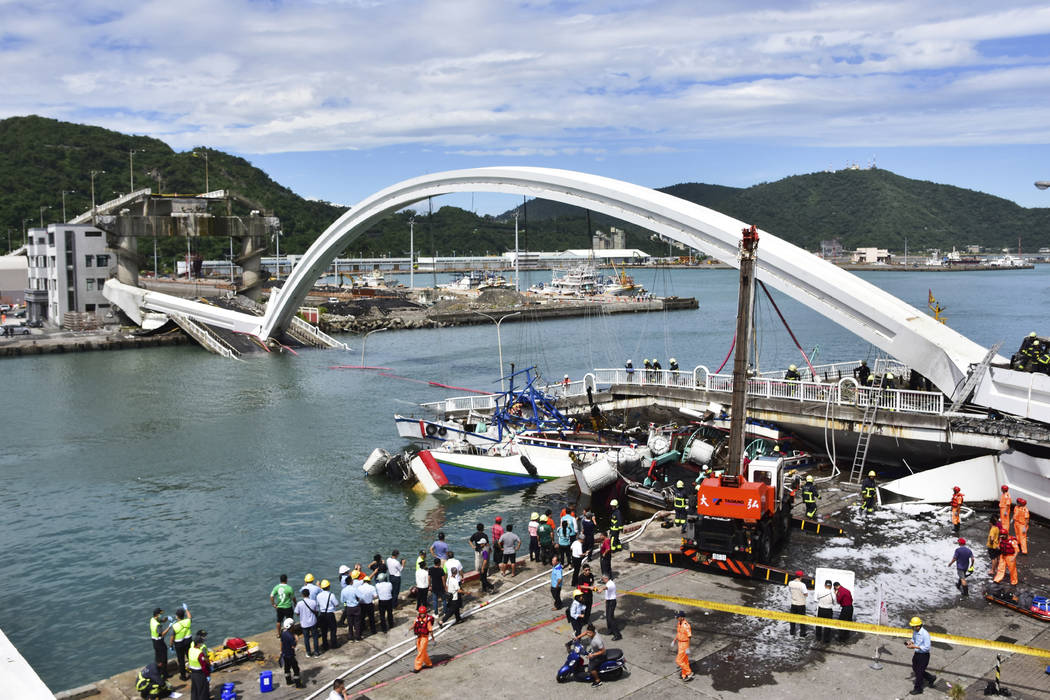 Rescuers work near the site of a collapsed bridge in Nanfangao, eastern Taiwan. Tuesday, Oct. 1 ...