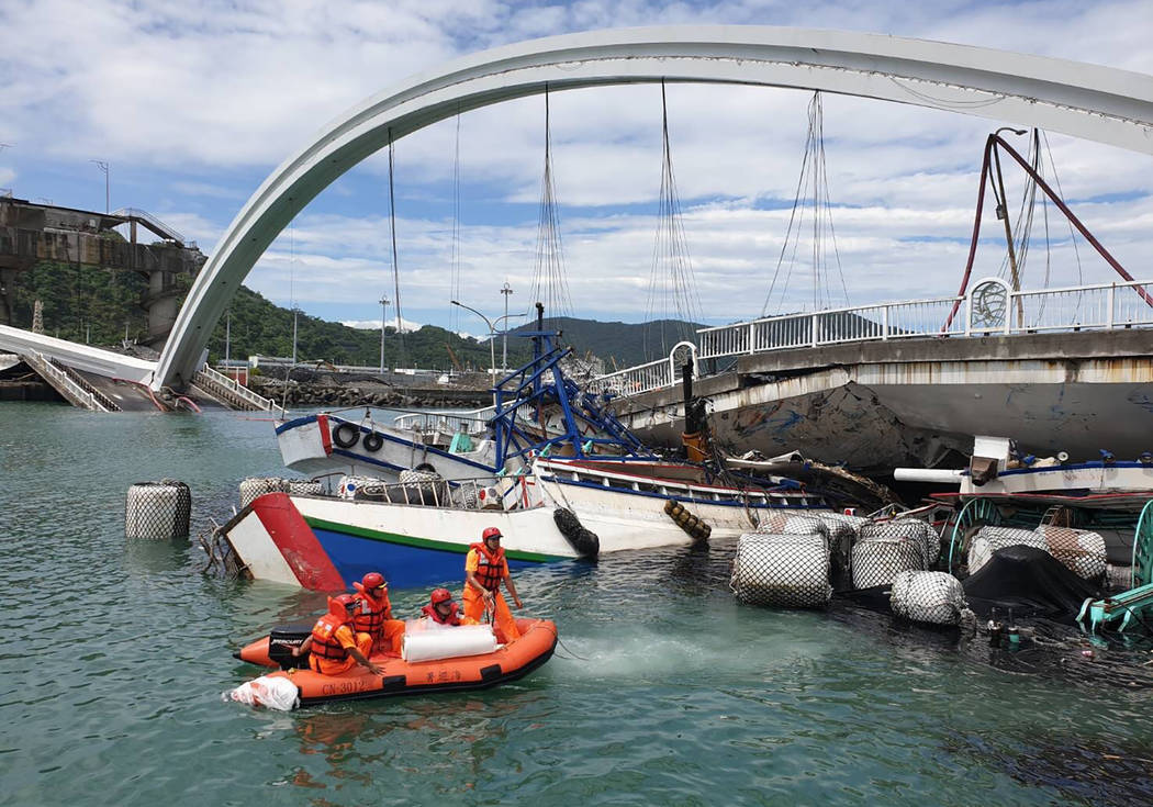 Rescuers work near the site of a collapsed bridge in Nanfangao, eastern Taiwan. Tuesday, Oct. 1 ...