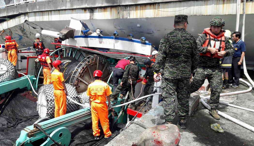 Rescuers work at the site of a collapsed bridge in Nanfangao, eastern Taiwan. Tuesday, Oct. 1, ...