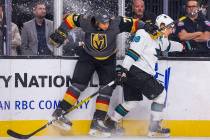 Vegas Golden Knights right wing Ryan Reaves (75) checks the boards with San Jose Sharks defense ...