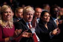 Prime Minister Boris Johnson applauds as he listens to Sajid Javid, Chancellor of the Exchequer ...