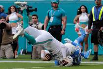 Los Angeles Chargers defensive back Desmond King (20) tackles Miami Dolphins quarterback Josh R ...