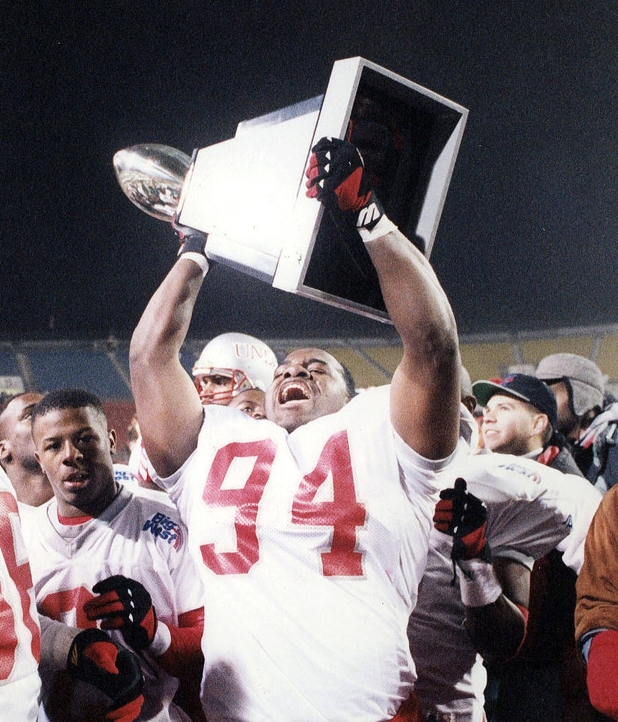 UNLV defensive lineman Aldwin Turnage holds the Las Vegas Bowl trophy after the Rebels' 52-24 v ...