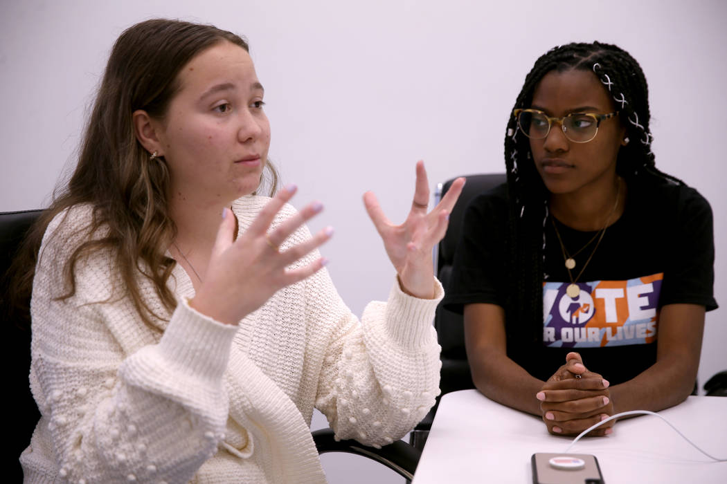 Lauren Hogg, 16, of Parkland Fla., left, and Ariel Hobbs, 21, of Houston, talk to a reporter in ...