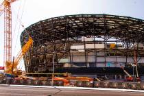 Crews install glass panes along the lower level of Allegiant Stadium on Tuesday, Sept. 10, 2019 ...