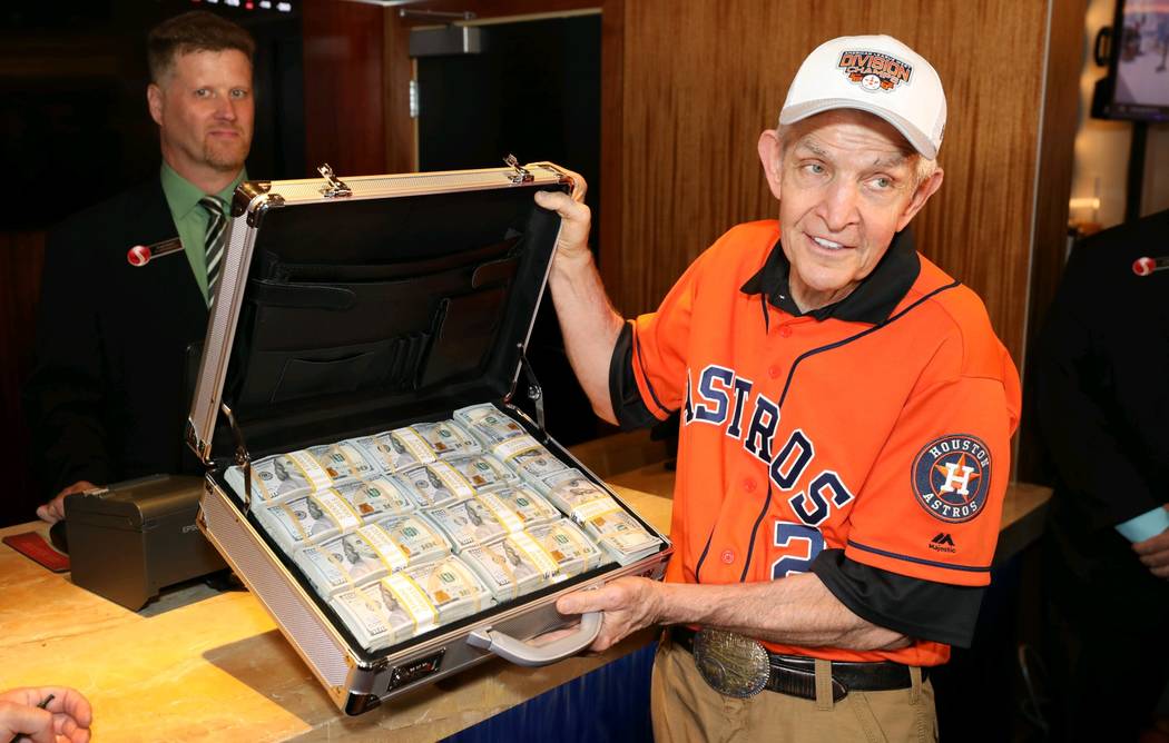 Jim “Mattress Mack” McIngvale holds a suitcase full of cash before making a $3.5 million wa ...