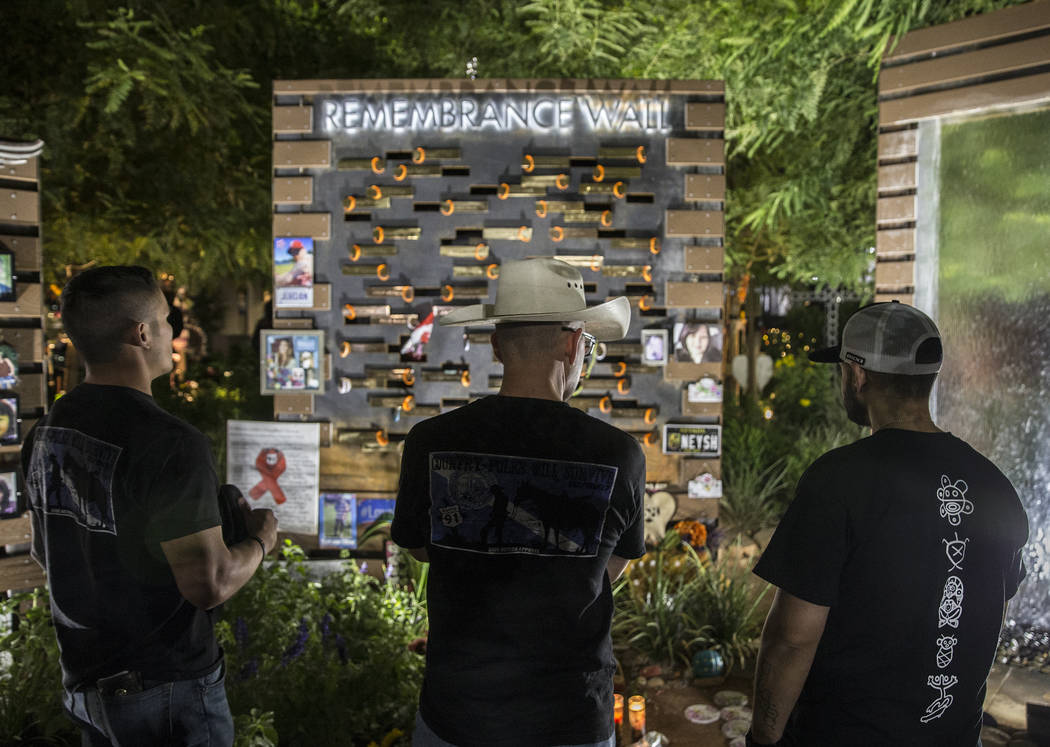 Visitors walk through the Las Vegas Community Healing Garden before the start of a ceremony hon ...