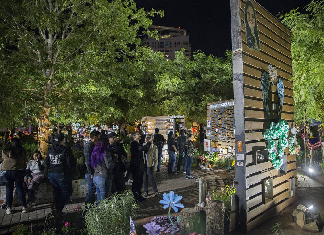 Visitors walk through the Las Vegas Community Healing Garden before the start of a ceremony hon ...